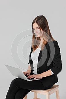 Portrait of young smiling brunette woman lady in business suit w