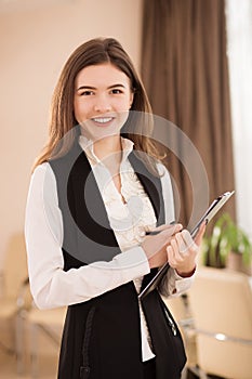 Portrait of Young Smiling Businesswoman with clipboard