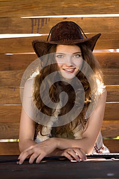 Portrait of young smiling cowgirl in stetson