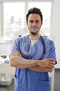 Portrait of young smiling doctor in the doctor\'s office