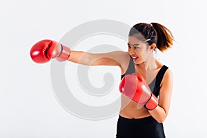 Portrait of a young smiling female boxer punching on white isolated background with copy space