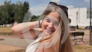 Portrait of a young smiling girl in the park on a summer day.