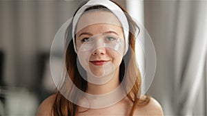 Portrait of Young Smiling Girl With Patches On The Face Under Eyes. Makeup and Beauty Treatments Concept. Skin Care, Spa