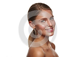 Portrait of a young smiling healthy and beautiful girl with nude makeup