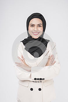 Portrait of young smiling muslim businesswoman wearing suit with hijab over white background studio