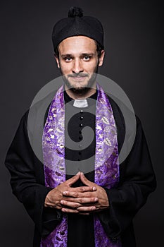 Portrait: young smiling priest