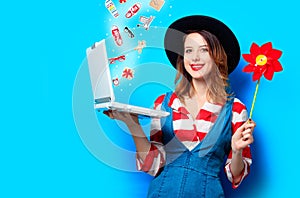 Woman with laptop and pinwheel and with gifts