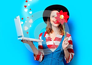 Woman with laptop and pinwheel with hearts