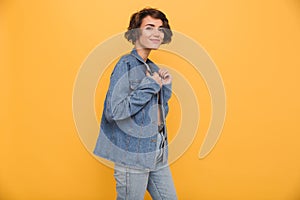 Portrait of a young smiling woman dressed in denim jacket