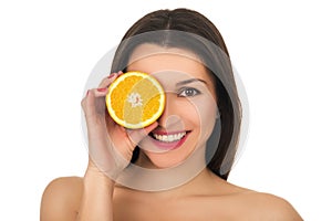 Portrait on young smiling woman with half of orange near face