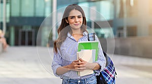 Portrait of young smiling woman holding books, study, education, knowledge, goal concept