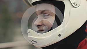 Portrait young smiling woman in a protective helmet slow motion