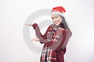 Portrait of young smiling woman wearing red Santa Claus hat isolated white background studio