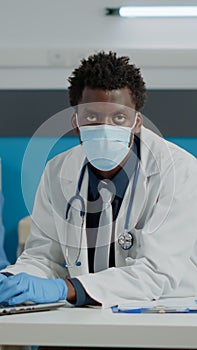 Portrait of young specialist using laptop sitting at desk