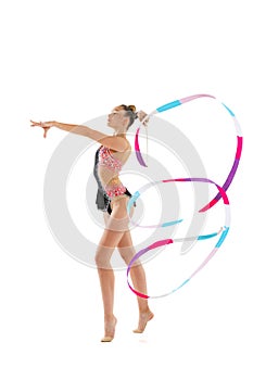 Portrait of young sportive girl, rhythmic gymnastics artist isolated on white studio background. Concept of sport
