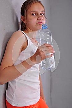 Portrait of young sportive teen girl with a bottle of drinking water