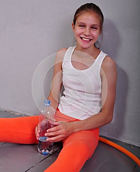 Portrait of young sportive teen girl with a bottle of drinking water