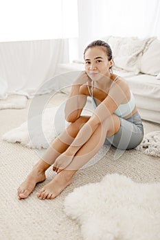 Portrait of a young sports girl at home after training.