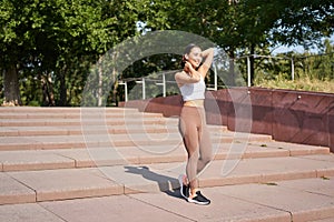 Portrait of young sportswoman running on street. Fitness girl jogging in park, workout outdoors, listening music in