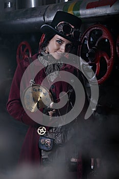 Portrait of a young steampunk woman with a clock face