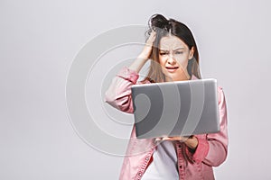 Portrait young stressed displeased worried business woman with laptop computer isolated over white background. Negative face
