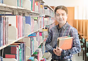 Portrait of young student smile and stand with book