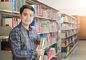Portrait of young student smile and stand with book