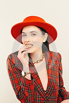 Portrait of young stylish girl. Fashion portret of elegant woman in hat and jacket. Studio shot