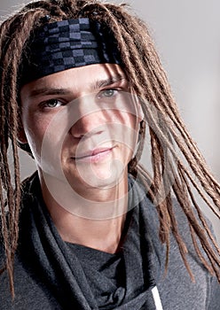 Portrait on young stylish guy with dreadlocks.