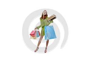 Portrait of young stylish woman standing with many shopping bags isolated oevr white background. Big sales season
