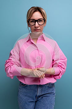 portrait of a young successful blond careerist leader woman in a pink blouse and glasses