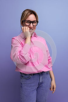 portrait of a young successful blond careerist leader woman in a pink blouse and glasses