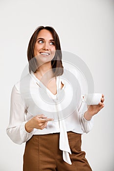 Portrait of young successful business woman over white background