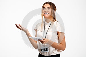 Portrait of young successful businesswoman over white background.