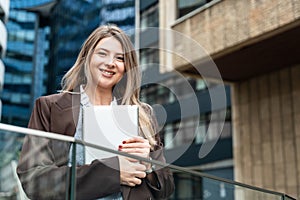 Portrait of young successful foreperson business woman outdoor. Cute intelligent female businessperson in smart casual wear