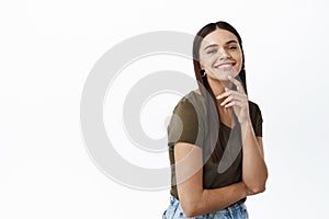 Portrait of young successful and happy woman smiling at camera, express joy and positive emotions, touching natural