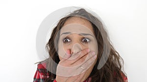 Portrait of young surprised and shocked teen girl on a white background. slow motion. 3840x2160