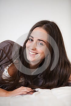 Portrait of a young and sweet natural woman without makeup with long brown hair