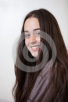 Portrait of a young and sweet natural woman without makeup with long brown hair