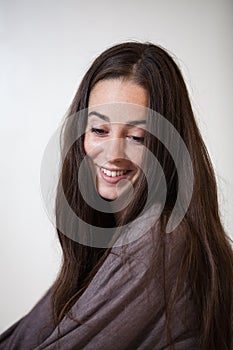 Portrait of a young and sweet natural woman without makeup with long brown hair