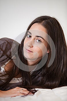 Portrait of a young and sweet natural woman without makeup with long brown hair