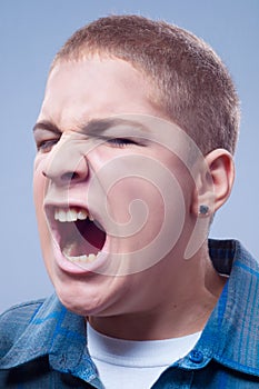 Portrait of young teenage boy screaming