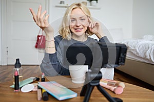 Portrait of young teenage girl in her room, recording a vlog, daily lifestyle video for social media, internet