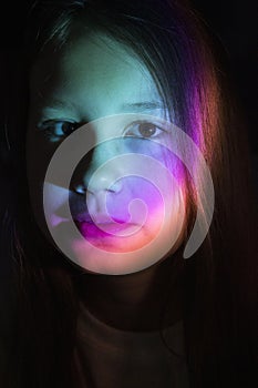 Portrait of young teenager girl in colored neon light.