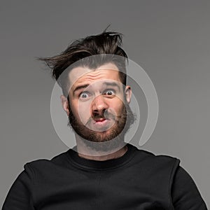 Portrait of young tousled man in studio