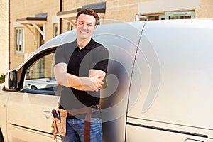 Portrait of a young tradesman by his van