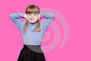 Portrait of young unhappy, stressed little girl covering her ears with fingers calling to stop noise isolated on pink