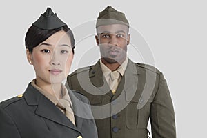 Portrait of young US military officers in uniform over gray background