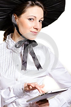 Portrait of young Victorian style business woman using laptop PC at her office