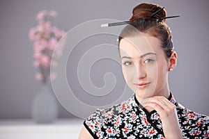 Portrait of young woman in asian outfit